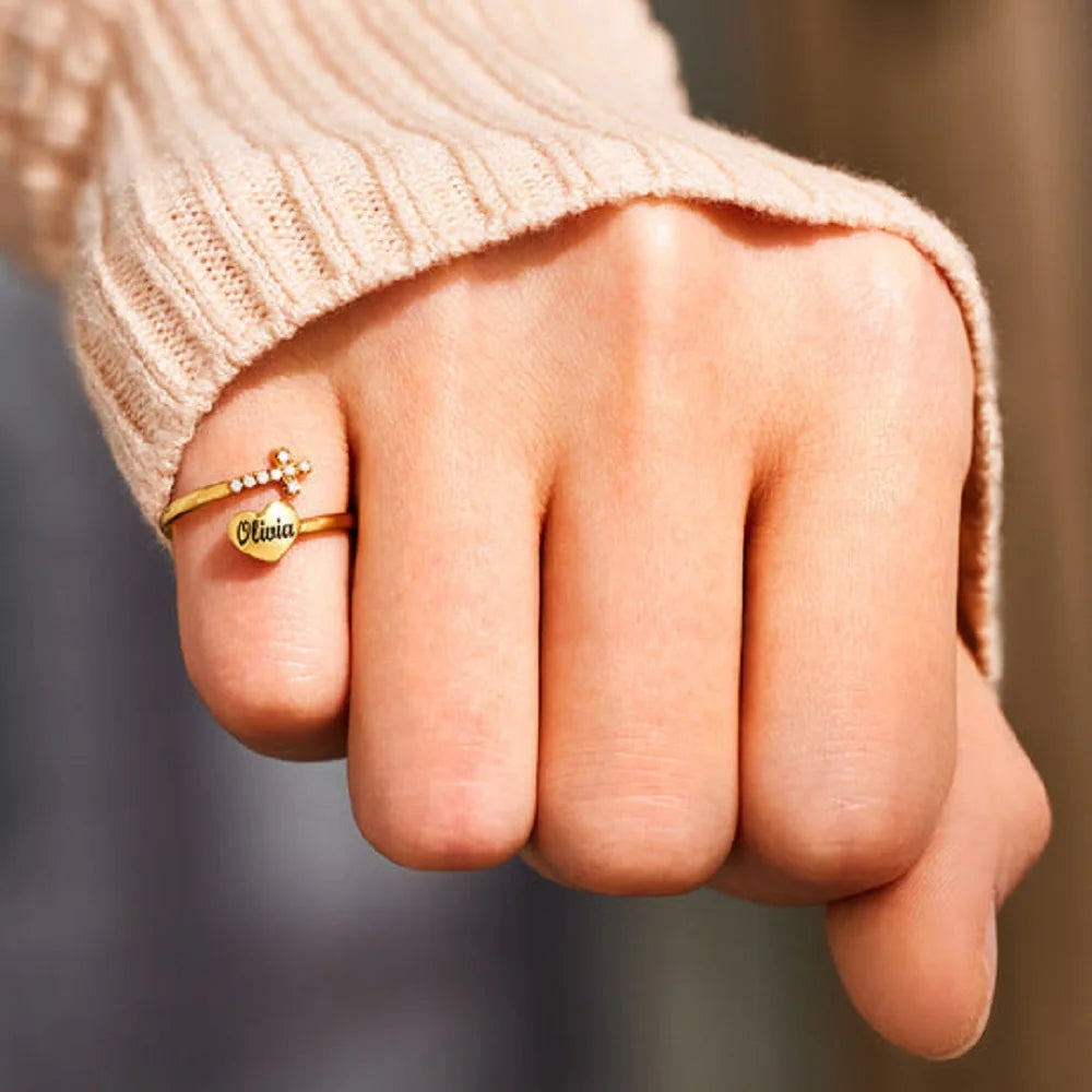 Personalized heart and cross ring with engraved letters, adorned with cubic zirconia, adjustable and made of stainless steel, perfect as a gift for loved ones and couples.